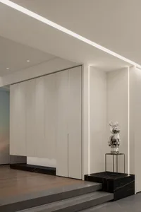 A minimalist interior design featuring concrete and metal elements.