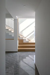 A minimalist interior space featuring marble and wooden elements.