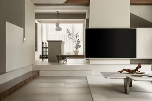 A minimalist living room with concrete and marble elements.