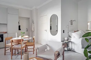 A minimalist living room with neutral-colored furniture and decor.