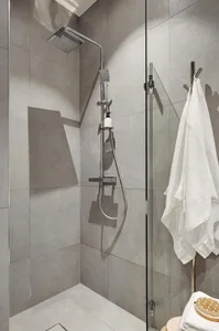 Modern bathroom featuring a concrete tile shower with a minimalist design.