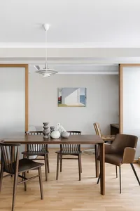A modern dining room featuring wooden furniture.