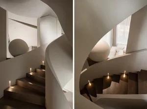Modern staircase featuring wooden steps and built-in lighting.