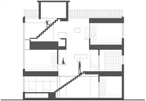 A 2D architectural drawing showing the layout of an interior space with stairs, rooms, and furniture placements.