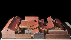 A model of a modern residential building constructed from brick material.
