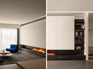 Modern minimalist living room with a concrete fireplace, blue accent chair, and built-in shelving.
