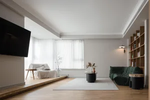 Modern minimalist living room with wooden furniture and a large television.
