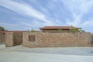 A traditional building with a white roof and brick walls and windows.