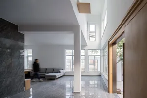 A modern living room with concrete walls and floors