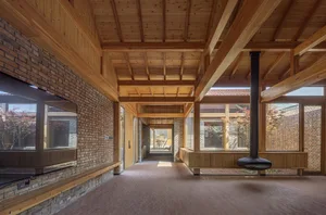 Modern, minimalist space featuring wooden walls, ceiling, and floors.
