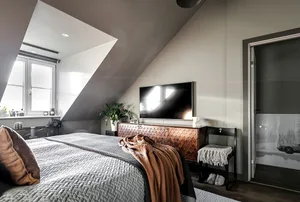 Modern minimalist bedroom with wood, metal, and natural-fiber materials, featuring a bed, TV, and window.