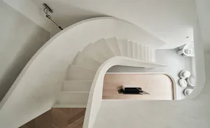 A modern white concrete staircase with smooth rounded edges.