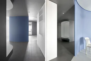 A minimalist apartment interior featuring a concrete floor and walls.