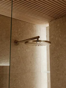 Modern minimalist bathroom featuring a sleek, metallic showerhead.