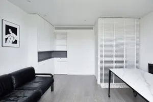 A minimalist office studio featuring marble and leather materials.