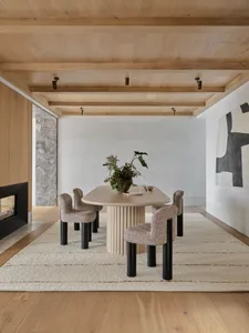 Modern dining room with a wooden table and chairs.