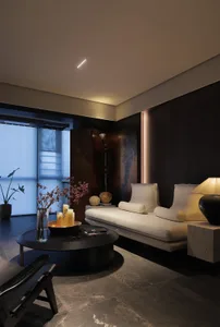 A modern living room featuring minimalist design with wooden furniture and a glass vase filled with bare branches.