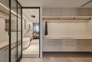 Modern minimalist closet featuring a neutral-toned color palette with natural materials, including a hanging rail for clothes