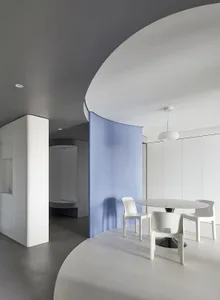 Modern minimalist interior design featuring polished concrete, white plaster walls, and glass elements.