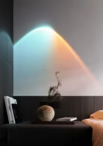 A minimalist bedroom featuring modern materials and a cozy reading nook with books and a vase.