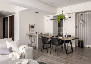 Modern minimalist living, dining, and kitchen space with sleek furniture and a neutral color palette.