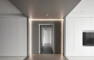 A modern, minimalist interior design featuring a concrete floor and white walls.