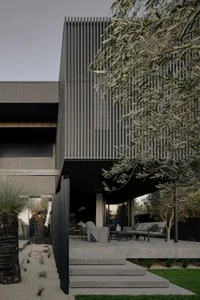 Modern metal-clad residential home exterior with a sleek, minimalist design.