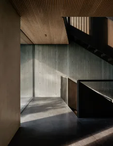 Concrete staircase and walls in an industrial-style interior design.