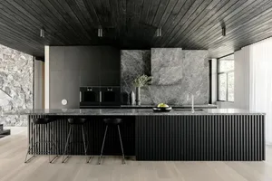 a modern residential kitchen featuring stone and marble elements