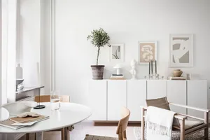 A minimalist living room with neutral-toned furniture and decor.
