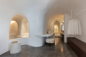 A modern bathroom with a concrete design featuring a built-in bathtub and a minimalistic vanity area.