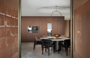A modern dining room featuring metallic furniture and fixtures.