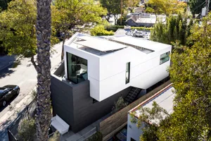 A modern house with a white exterior and concrete elements.