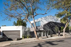 A modern residential home with a combination of wood, metal, and glass materials.