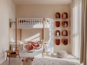 A minimalist children's bedroom featuring a white bunk bed with orange and white bedding, a small side table, and decorative 