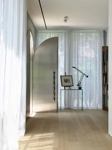 Modern interior design featuring a glass window, wooden floor and light fixture.