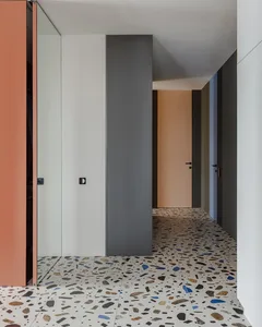 A modern interior design featuring a corridor with a terrazzo floor.