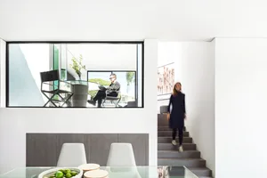 A modern interior design featuring white spaces and minimalist furniture.