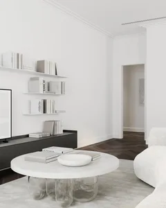 A minimalist living room with a white marble table, glass spherical legs, and black floating shelves.