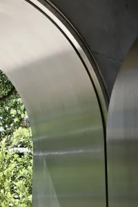 Steel arches against a natural backdrop