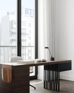 Modern minimalist home office featuring a wooden desk, leather chair, and metal lamp with an open book on the desk.