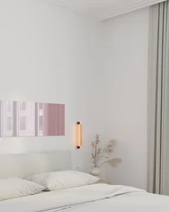 A modern minimalist bedroom with a neutral color palette, featuring a textured headboard and a vase with pampas grass on a ni