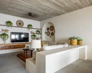 A contemporary living room with a white concrete sofa, providing minimalist and sleek contemporary design elements.