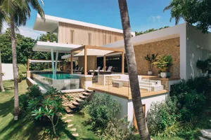 Modern house with glass, wood, and concrete exterior features.