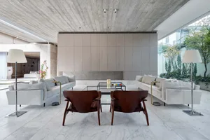 A modern living room with marble flooring, minimalist furniture, and clean lines.