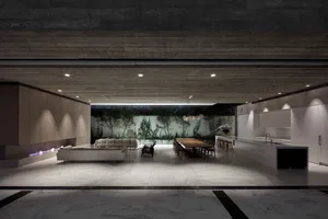A modern living room featuring a marble floor and concrete walls.