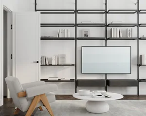 A modern living room featuring a white armchair, a circular white coffee table with a white bowl and magazines, and a wall-mo