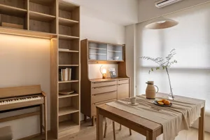 A cozy modern living room with wooden furniture, a table, and a bookshelf.