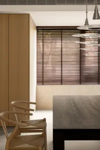 Modern dining room featuring wooden furniture and stone floor.