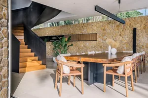 Modern living room featuring wooden furniture and stone accents.